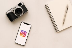 Flat lay of smartphone and camera setup for Instagram content planning